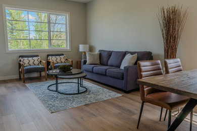 Living room - vinyl floor and brown floor living room idea in Other