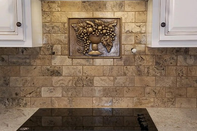 Natural stone kitchen backsplash with decorative insert