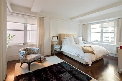 Example of a mid-sized trendy master dark wood floor bedroom design in New York with white walls and no fireplace