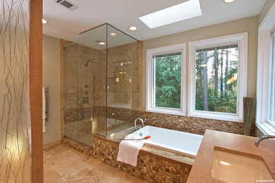 Large transitional master beige tile and stone tile travertine floor bathroom photo in Atlanta with an undermount sink, flat-panel cabinets, light wood cabinets, marble countertops, a two-piece toilet and beige walls