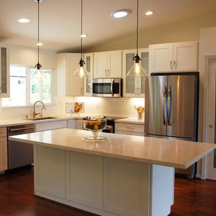 Mid-sized transitional kitchen pantry photos - Mid-sized transitional l-shaped dark wood floor kitchen pantry photo in Hawaii with an undermount sink, white cabinets, quartz countertops, white backsplash, subway tile backsplash, stainless steel appliances, an island and shaker cabinets