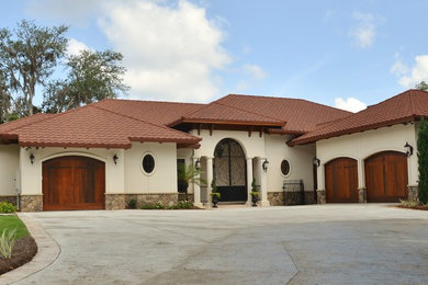 Mid-sized mediterranean beige one-story mixed siding gable roof idea in Miami