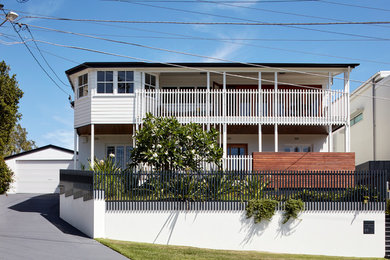 Photo of a contemporary two-storey white house exterior in Brisbane with mixed siding.