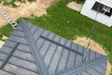 Exterior home photo in Toronto with a metal roof and a black roof