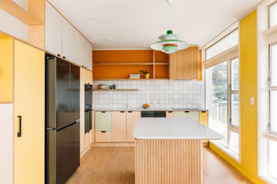 Design ideas for a small midcentury kitchen in Wellington with cork floors.