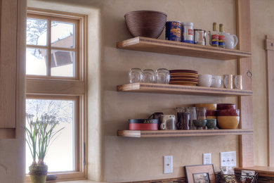 Mid-sized trendy l-shaped light wood floor eat-in kitchen photo in Other with a drop-in sink, shaker cabinets, multicolored backsplash, glass tile backsplash, stainless steel appliances and light wood cabinets