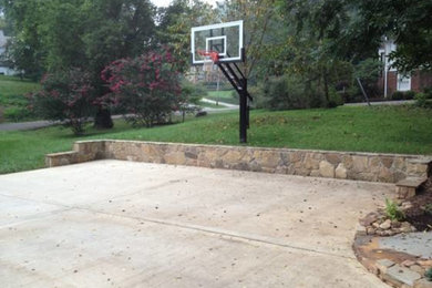 Photo of a large traditional backyard outdoor basketball/tennis/multi-game court in Houston.
