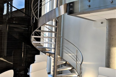 Design ideas for a modern spiral metal railing staircase in Edmonton with metal risers.