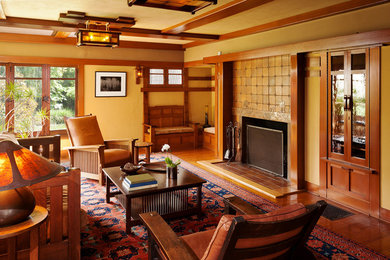 Example of a large arts and crafts formal and enclosed medium tone wood floor living room design in Los Angeles with green walls, a standard fireplace, a tile fireplace and no tv