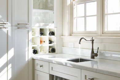 Eat-in kitchen - mid-sized transitional single-wall medium tone wood floor, brown floor and shiplap ceiling eat-in kitchen idea in Other with a double-bowl sink, recessed-panel cabinets, white cabinets, granite countertops, white backsplash, granite backsplash, stainless steel appliances, an island and white countertops