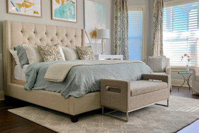 Large beach style master bedroom in Orlando with grey walls, dark hardwood floors and brown floor.