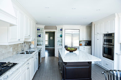 Example of a transitional kitchen design in Toronto with an island