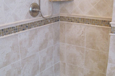 Inspiration for a large beige tile corner shower remodel in New York
