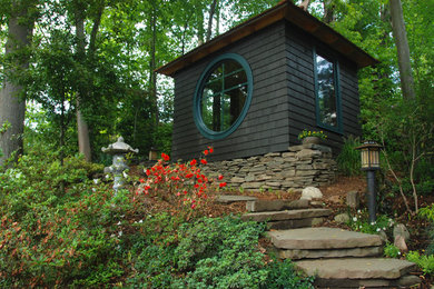 Inspiration for a small asian partial sun hillside stone landscaping in New York.