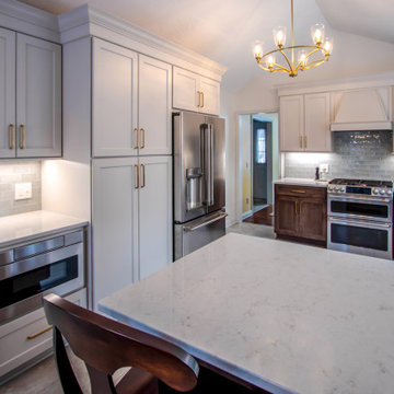 Two Tone Kitchen with Wood and Beige Cabinetry with Quartz Countertops