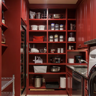 This is an example of a classic u-shaped utility room in St Louis with a submerged sink, recessed-panel cabinets, red cabinets, granite worktops, beige walls, porcelain flooring, a side by side washer and dryer and beige floors.
