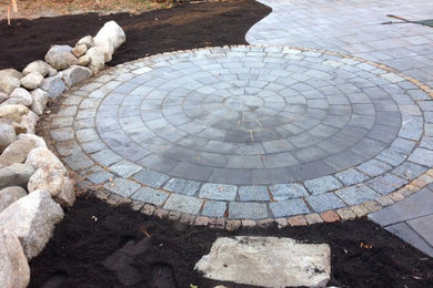 Outdoor Fire Pit area with a Circle  Patio framed with Cobblestone