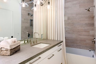 Mid-sized beach style brown tile limestone floor bathroom photo in Santa Barbara with flat-panel cabinets, white cabinets, white walls, an undermount sink and concrete countertops