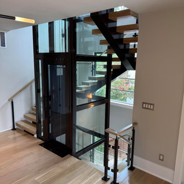 Project #136 | Modern Floating Staircase Encircling Glass Elevator