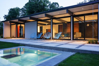 Inspiration for a large mid-century modern gray two-story wood exterior home remodel in Raleigh