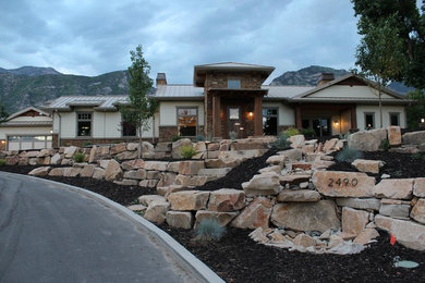 Inspiration for a rustic beige one-story mixed siding exterior home remodel in Salt Lake City with a hip roof