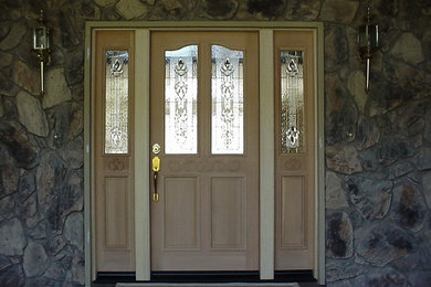 Photo of a mid-sized front door in Sacramento with a pivot front door and a light wood front door.