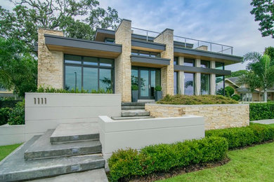 Example of a large minimalist multicolored two-story mixed siding exterior home design in Tampa