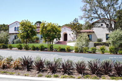 Large mediterranean white two-story stucco exterior home idea in San Francisco with a tile roof