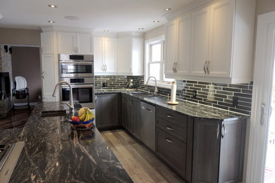 Inspiration for a large contemporary galley kitchen in Ottawa with an undermount sink, shaker cabinets, dark wood cabinets, granite benchtops, black splashback, ceramic splashback, stainless steel appliances and ceramic floors.