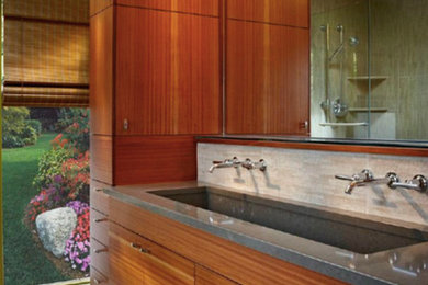 Inspiration for a mid-sized modern master beige tile ceramic tile bathroom remodel in Portland with a trough sink, flat-panel cabinets and medium tone wood cabinets