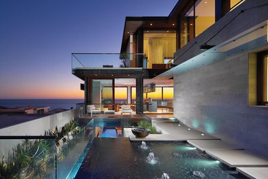 Trendy backyard custom-shaped pool photo in Orange County