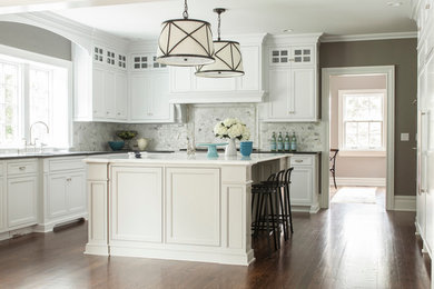 Enclosed kitchen - traditional u-shaped dark wood floor enclosed kitchen idea in New York with beaded inset cabinets, white cabinets, granite countertops, white backsplash and paneled appliances