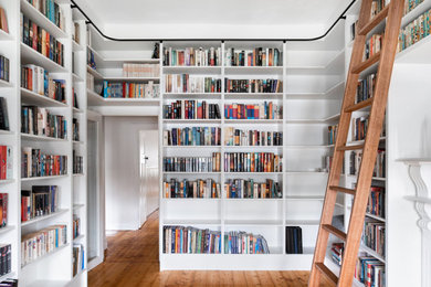 Large contemporary home office in Melbourne with a library.