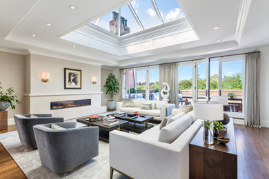 Example of a transitional open concept medium tone wood floor, vaulted ceiling and wallpaper living room design in Boston with beige walls, a ribbon fireplace and a stone fireplace