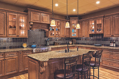 Eat-in kitchen - traditional light wood floor eat-in kitchen idea in Philadelphia with an undermount sink, raised-panel cabinets, medium tone wood cabinets, granite countertops, stone tile backsplash and stainless steel appliances
