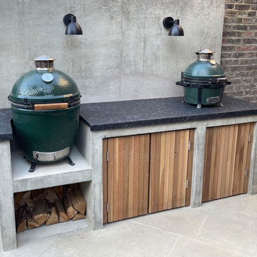 London, Islington. Tiny garden with outdoor fireplace and built-in barbecue area