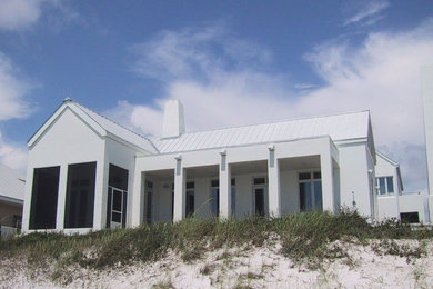 Mid-sized trendy white one-story stucco gable roof photo in Miami
