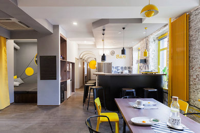 This is an example of a medium sized urban u-shaped kitchen/diner in Moscow with an integrated sink, black cabinets, wood worktops, black splashback, ceramic splashback, stainless steel appliances, dark hardwood flooring, no island, brown floors and brown worktops.