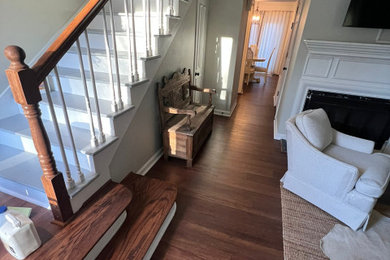 Inspiration for a mid-sized wood railing staircase remodel in Atlanta with wooden risers