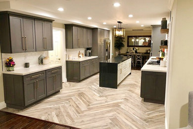 Eat-in kitchen - mid-sized country galley porcelain tile and gray floor eat-in kitchen idea in Orange County with an undermount sink, shaker cabinets, gray cabinets, quartzite countertops, white backsplash, subway tile backsplash, stainless steel appliances, an island and white countertops