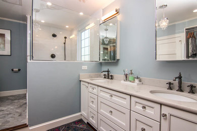 Inspiration for a large timeless master white tile and subway tile porcelain tile and gray floor corner shower remodel in Chicago with recessed-panel cabinets, white cabinets, a two-piece toilet, blue walls, an undermount sink, quartzite countertops, a hinged shower door and gray countertops