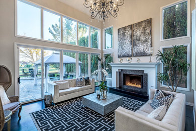Large transitional formal open concept living room in Las Vegas with grey walls, dark hardwood floors, a standard fireplace, a tile fireplace surround and black floor.