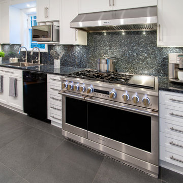 Functional & Stylish White Kitchen with Dark Countertops and Backsplash