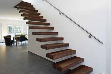 Design ideas for a mid-sized contemporary wood straight staircase in Other with open risers and metal railing.
