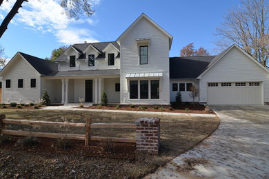 Example of a cottage white two-story exterior home design in Other