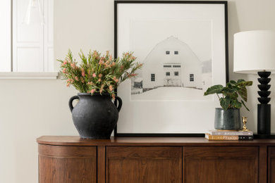 Inspiration for a mid-sized transitional open concept medium tone wood floor living room remodel in Burlington with a corner fireplace and a wood fireplace surround