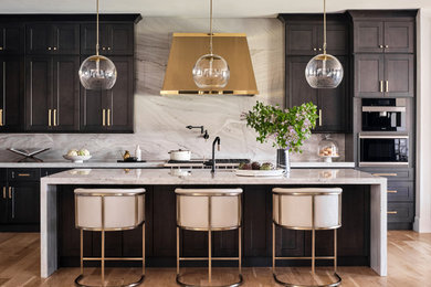 Example of a mid-sized transitional galley light wood floor and beige floor kitchen design in Denver with an undermount sink, shaker cabinets, dark wood cabinets, quartzite countertops, white backsplash, stone slab backsplash, stainless steel appliances, an island and white countertops