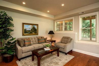 Inspiration for a mid-sized timeless walk-out dark wood floor basement remodel in Atlanta with beige walls