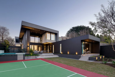 Large contemporary split-level multi-coloured house exterior in Melbourne with a flat roof.