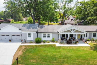 Inspiration for a huge gray one-story painted brick gable roof remodel in St Louis with a shingle roof and a gray roof